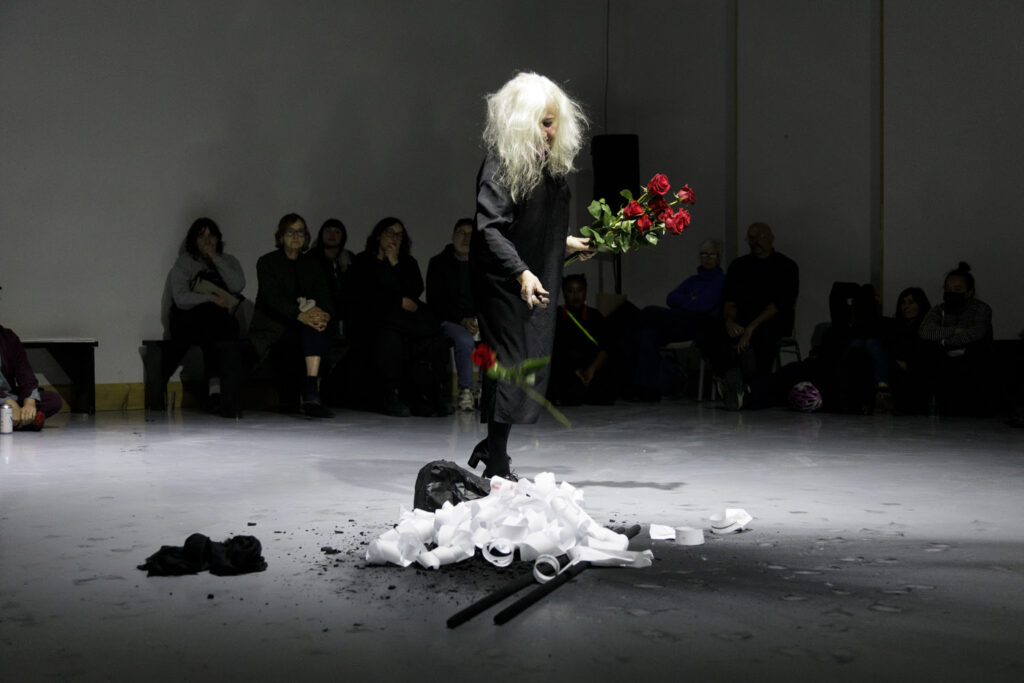 Irma Optimisti performs with red roses in  ViVa! Art Action Montreal event at Novempber 2025. Photo: Paul Litherland